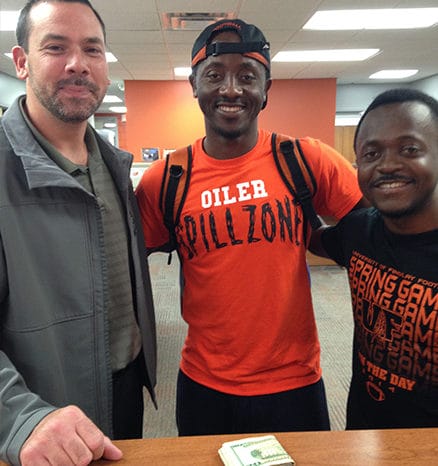 Findlay African Student Association members donate money to Dr. Rick Dudley to help combat Ebola.