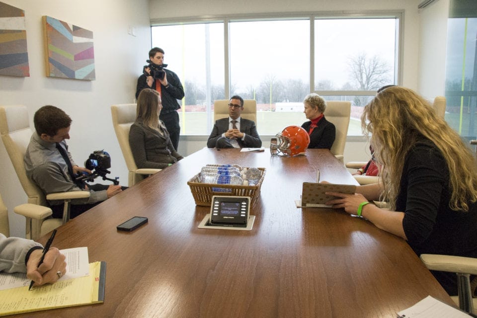 Katherine Fell, Ph.D., president of The University of Findlay, far left, and Cleveland Browns President Alec Scheiner seal the deal on The University of Findlay & Cleveland Browns Partnership for Student Success