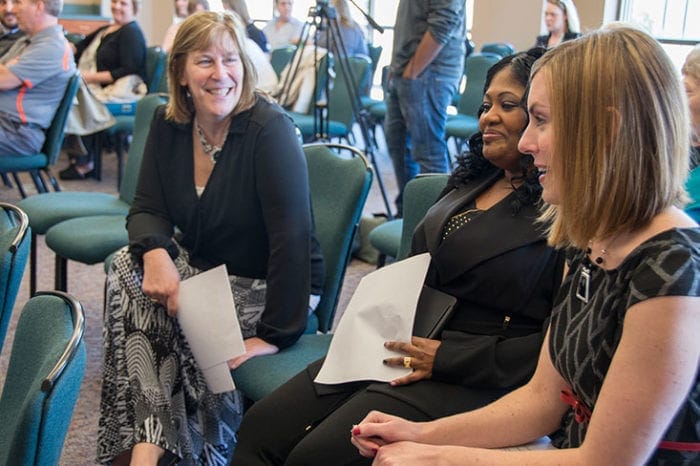 From left, Theresa Scherger, Michelle "Keisha" (Williams) Savage and April Adams chat before the Symposium begins.