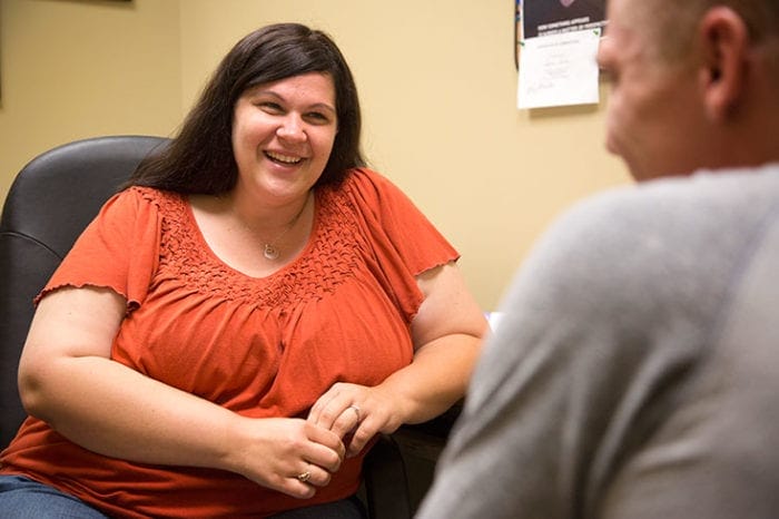 two people laughing and talking together