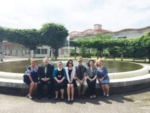 group sitting by fountain