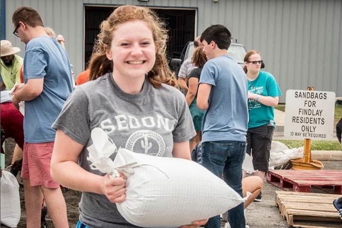 student holding a bag of sand