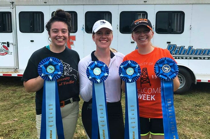 UF eventing students holding first place ribbons