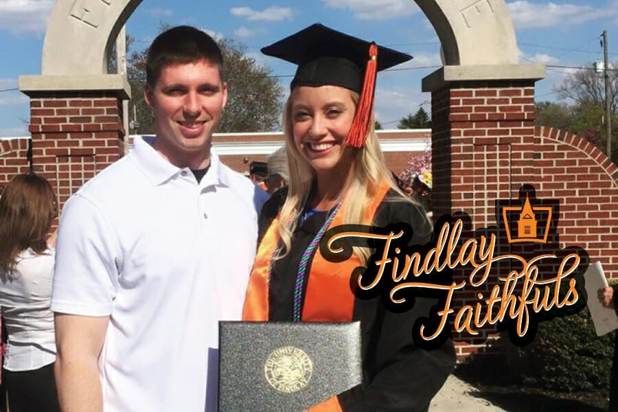 graduation photo in front of the arch
