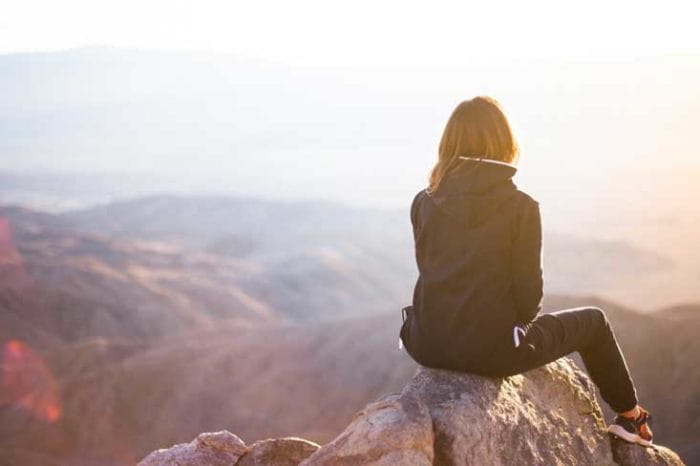 stock_woman sitting on rock