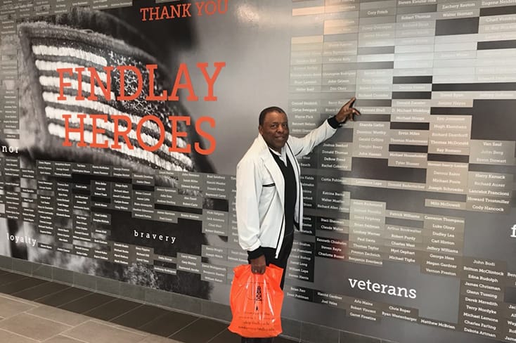 Crowder pointing at a name on the Findlay Heroes wall