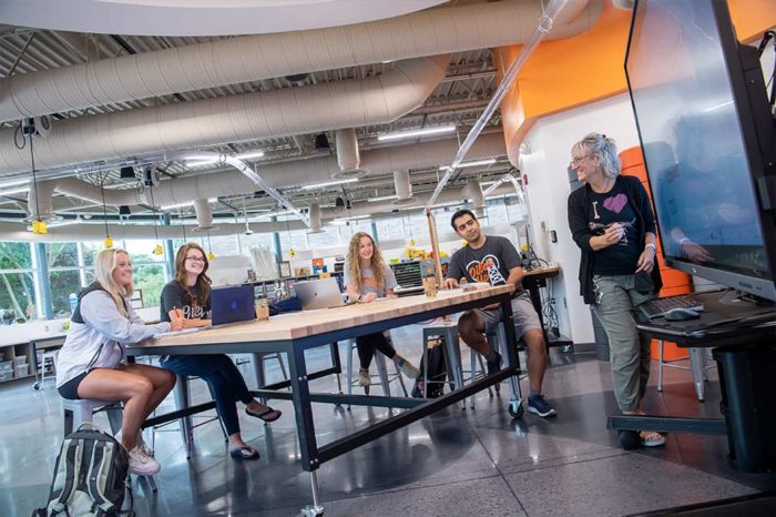 Addressing Educator Shortages photo with students and Kerry Teeple in the STEAM center