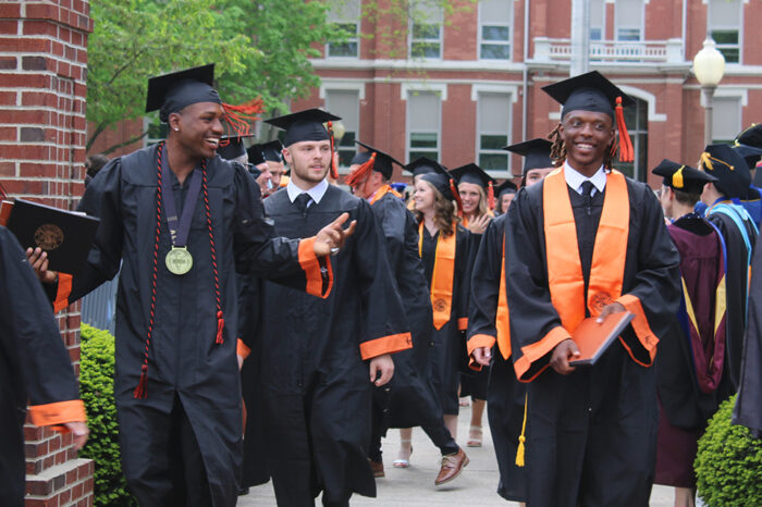 students walking under arch