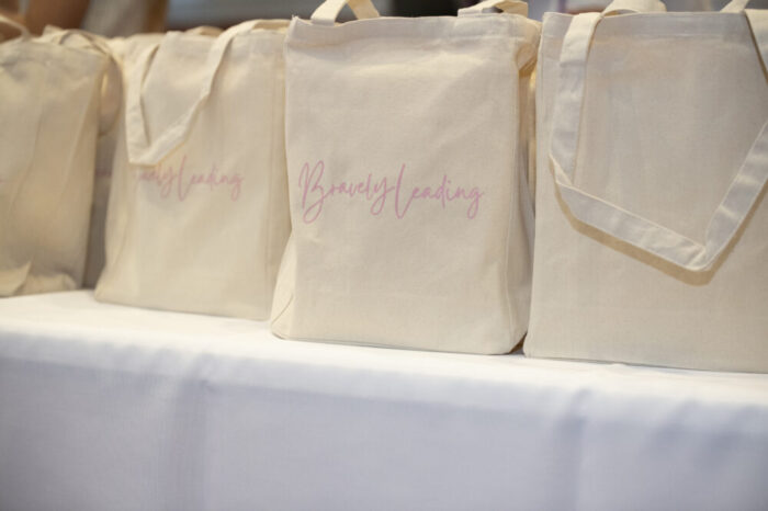 Close up of "Bravely Leading" logo on handbag at event