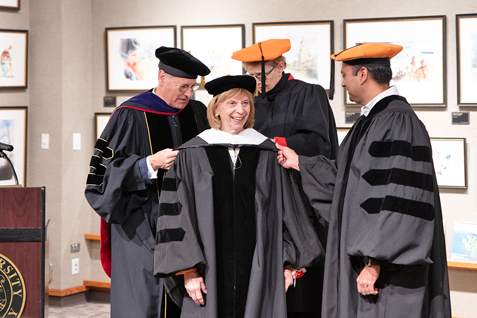 Ohio First Lady Fran DeWine (middle) is ceremoniously hooded by University of Findlay President Richard Ludwick, J.D., D.Ed. (left), President Emerita Katherine Fell (back middle), Ph.D., and Trustee Gulshan Mehta (right).